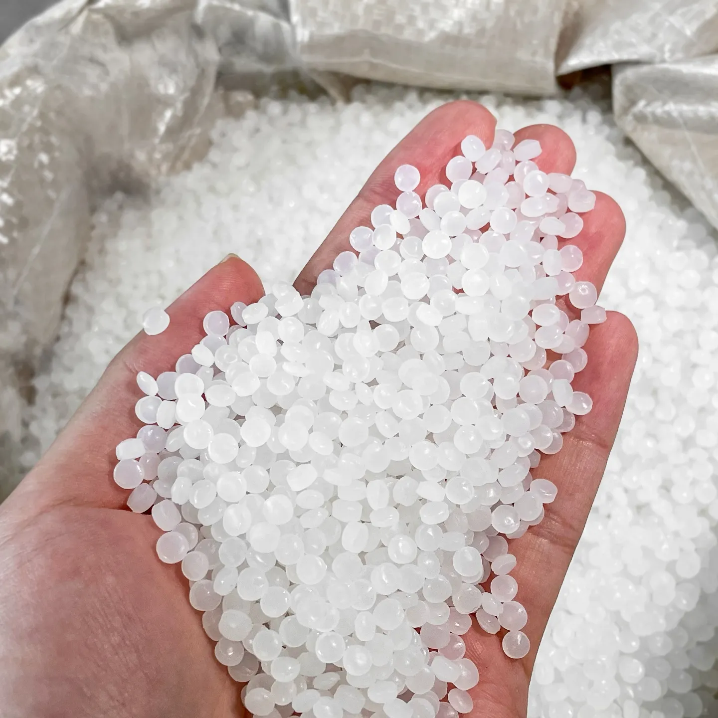 Handful of high-quality recycled PE pellets produced on a plastic pelletizing line