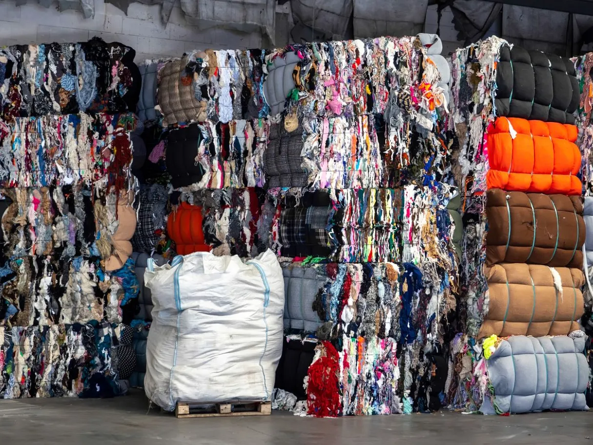 Baled textile fabric nonwoven and carpet waste for shredding